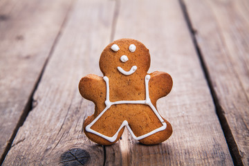 Christmas homemade gingerbread man on wooden table