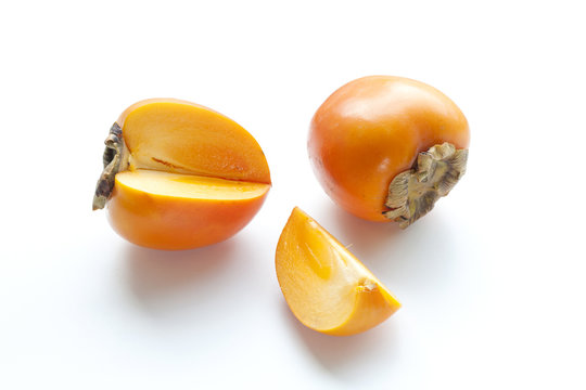 Ripe persimmon with cut isolated on white background. Clipping Path