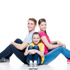 Happy young family with kid sitting.