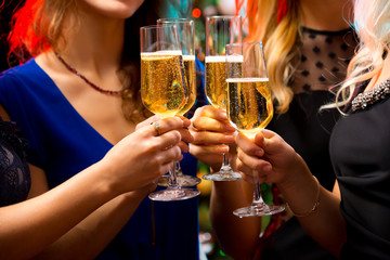 Women's hands with crystal glasses of champagne