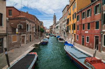 Fototapeta na wymiar VENICE, ITALY - MAY 16, 2010: Boats at a channel in Venice, Ital
