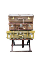 Old suitcases travel / Old suitcases travel resting on a wooden stool and isolated on white background.