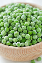 frozem peas on wooden surface