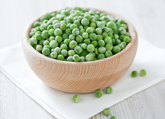 frozem peas on wooden surface