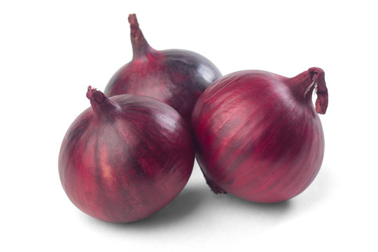 ripe red onions on a white background