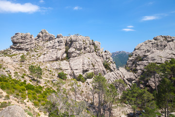 Fototapeta na wymiar Wild mountain landscape, rocks under blue sky