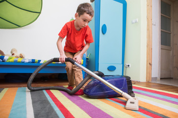 boy cleaning  floor with hoover
