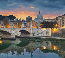 Fototapeta na wymiar Rome. View of Vittorio Emanuele Bridge and the St. Peter's cathedral in Rome, Italy during sunset.