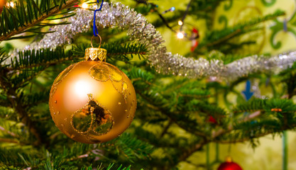 Beautiful colorful christmas decorations hanging on christmas tr