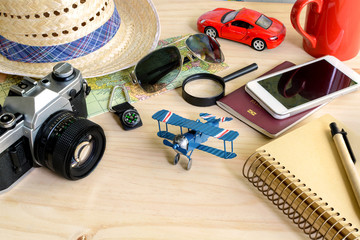 Travel and vacation accessories on wooden background