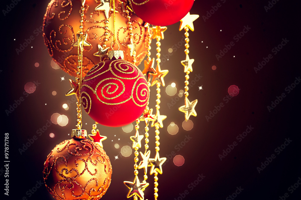 Canvas Prints Hanging Christmas baubles and garland over dark background