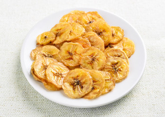 Banana chips on white plate
