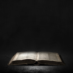 Old book in darkness