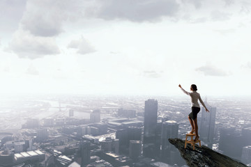 Woman reaching hand up