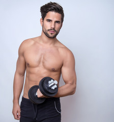 handsome young bodybuilder with toned body posing shirtless