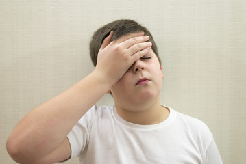 Portrait of  teenage boy with a headache