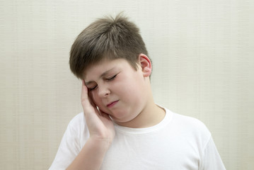 Portrait of  teenage boy with a headache