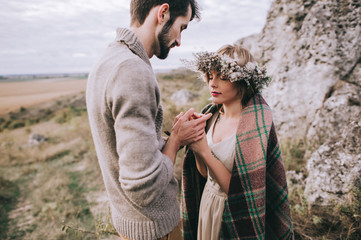 beautiful young couple on a background of rock cliff