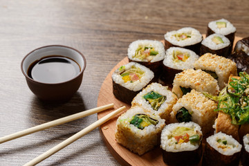 Sushi set at round wooden plate 