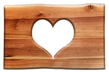 Heart shape cut in a wooden board isolated on white. Love symbol