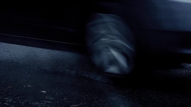 Closeup Of Cars Passing In The Rain