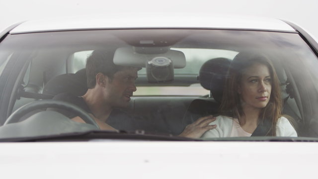  couple disagree and then make up and hug in a car