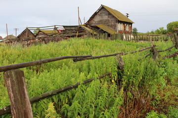 Fototapeta na wymiar Very old wooden house in the remote Russian village in summer