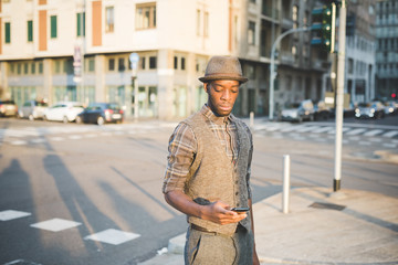 Knee figure of young handsome afro black man in city sunset hold