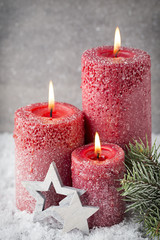 Three red candles on gray background, Christmas decoration. Adve