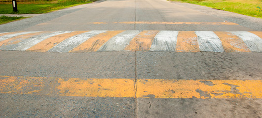 The speed bumps on the road by white and yellow color