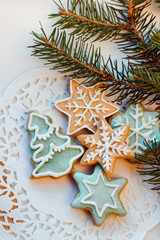 Christmas cookies with festive decoration and twigs of Christmas tree
