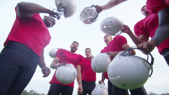 American football players in team talk, psyching themselves up for the game