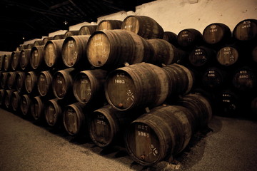wooden barrels hold Port fortified wine to mature in wine cellars , Portugal 