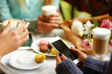Woman taking photo of food in cafe