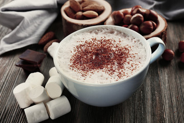 Cup of hot cacao with marshmallow on wooden background, close up