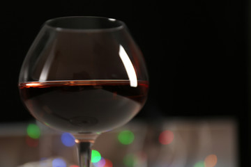 Wine glass with bokeh on dark background