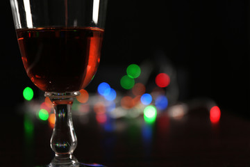 Wine glass with bokeh on dark background