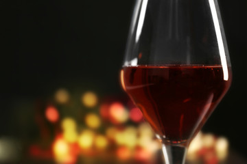 Wine glass with bokeh on dark background
