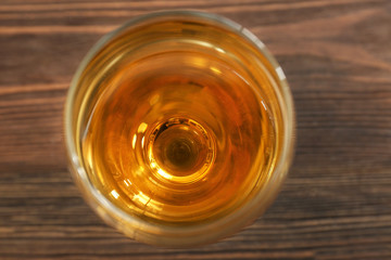 Glass of wine on wooden table. Top view