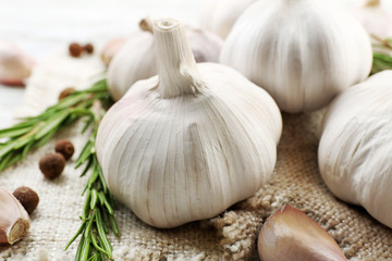 Composition of garlic and rosemary on sacking, close up