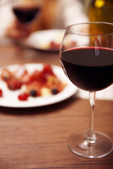 Glass with red wine on the table