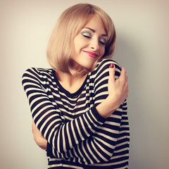 Happy casual woman hugging herself with natural emotional on enj