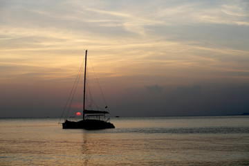 Amazing sunset view with catamaran on the sea.