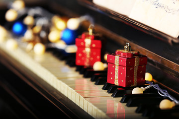 Piano keys decorated with Christmas decorations, close up