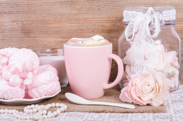 Cute set of pink princess accessories and sweets. Bottle with mastic flowers, big peach rose, zefir, cup of cacao with marshmellow, little spoon and pearl jewerly.