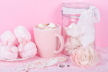 Cute set of pink princess accessories and sweets. Bottle with mastic flowers, big peach rose, zefir, cup of cacao with marshmellow, little spoon and pearl jewerly.
