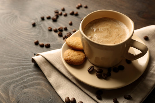 Cup of coffee on wooden table background