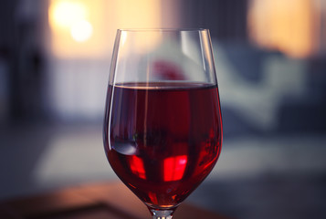 Glass of red wine on blurred background