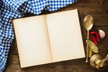 Open cookbook with kitchenware