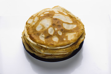 Pancakes on a plate on a white background